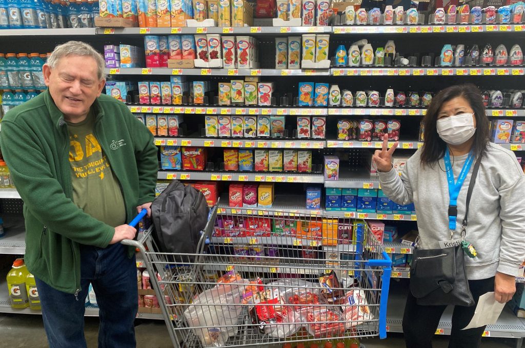 senior gentleman shopping with senior escort